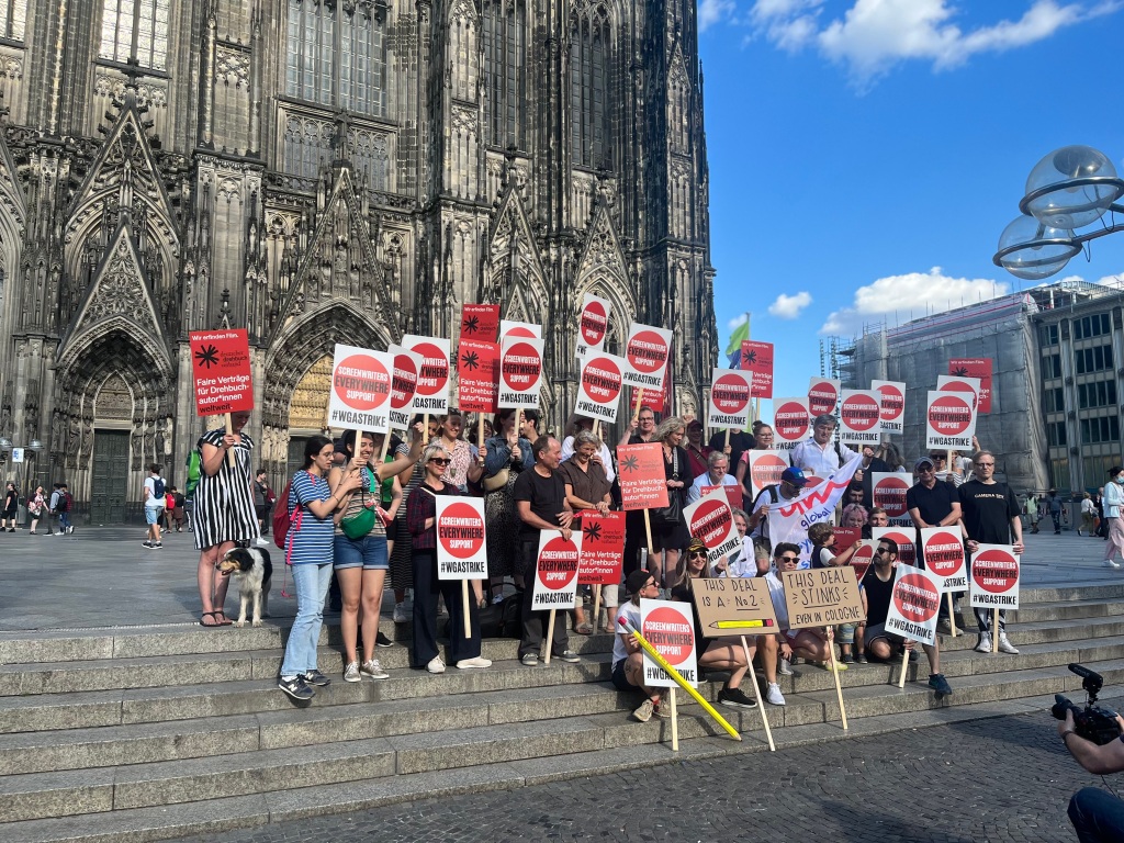 German Writers Unite in Solidarity at Cologne Cathedral Protest: “We Are Today… WGA!”